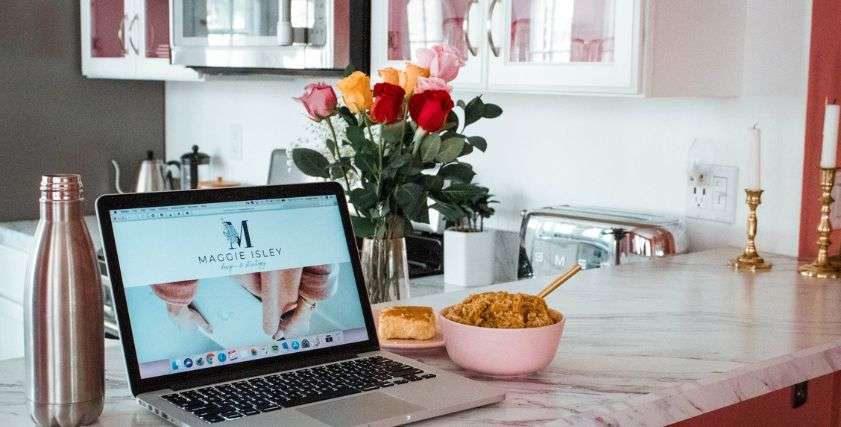 open laptop and food on the kitchen counter